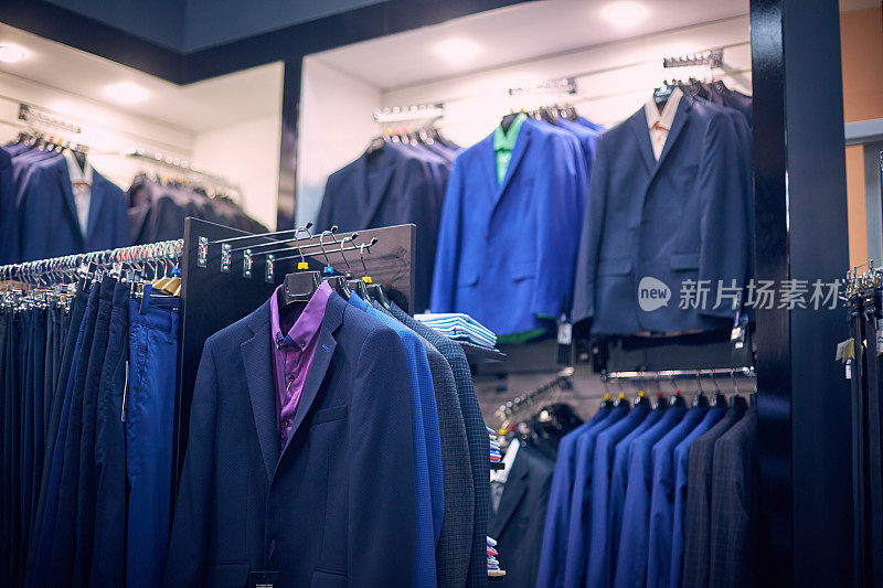Men's jackets on hangers in the men's store.